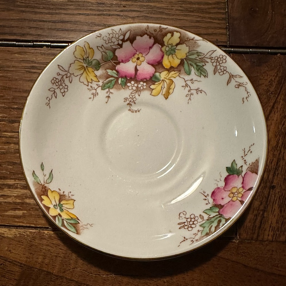 Adderley china saucer with pink and yellow flowers.